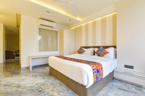 a bedroom with a large bed in a room at FabHotel Prime The Grey Circle in Indore