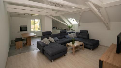 a living room with a couch and a table at gîtes gorevirat in Corcelles