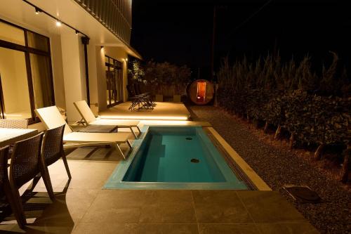 a swimming pool in the middle of a patio at night at Nanki Shirahama Villa IRIS in Kanayama