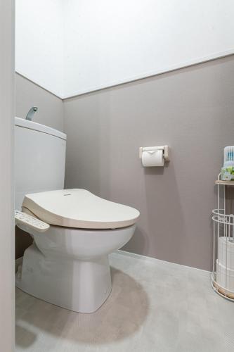 a bathroom with a toilet and a roll of toilet paper at 吉房民宿 YOSHIFUSA House 晴空塔徒步圈 整栋出租 in Tokyo
