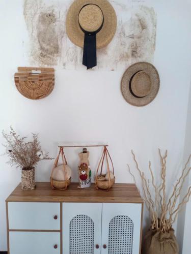 a room with hats on the wall and a cabinet at Hoàng Nga 2 Homestay in Phan Thiet