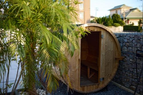 a wooden door in a wall with a palm tree at Nanki Shirahama Villa IRIS in Kanayama