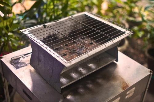 a grill sitting on top of a table at Kiansom Homestay - Waterfall etc in Kota Kinabalu