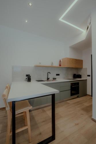 a kitchen with a table and a sink in a room at NIAMA Luxury apartments Nafplio in Nafplio