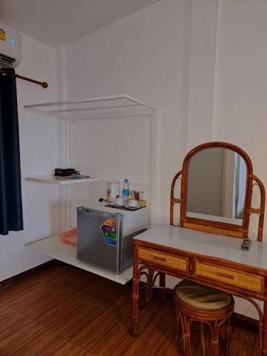 a room with a table and a mirror and a table and stool at Holiday Resort - SHA Plus in Ko Yao Noi