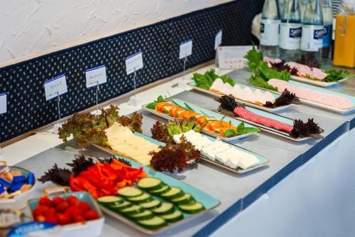 a buffet line with different types of food on plates at Hotel Sonne in Bad Homburg vor der Höhe