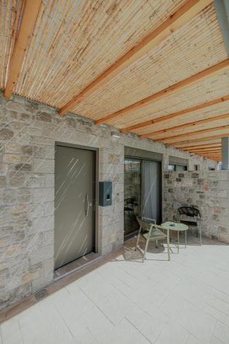 a patio with a door and a table and chairs at NIAMA Luxury apartments Nafplio in Nafplio