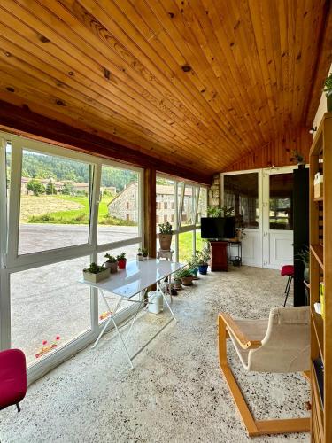 un salon avec un plafond en bois et une table dans l'établissement L'Ostal de Soubrey, à Salettes