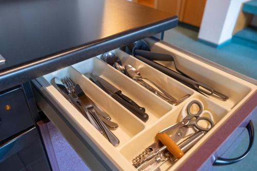 a drawer in a kitchen with utensils in it at Hotel Sonne in Bad Homburg vor der Höhe