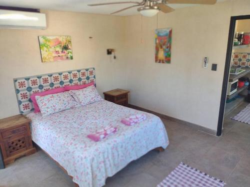 a bedroom with a bed with pink dolls on it at Beautilful ocean views from this apartment in Chelem