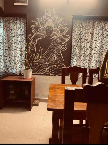 a dining room with a painting on the wall at The Varkala Retreat Villa in Varkala