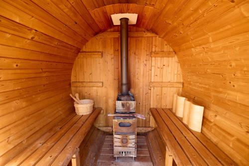 an inside of a wooden cabin with a stove at Nanki Shirahama Villa IRIS in Kanayama