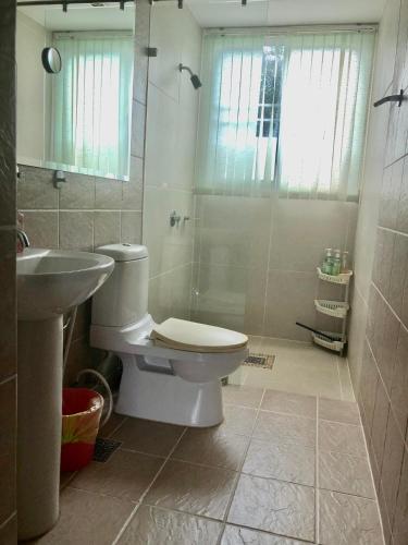 a bathroom with a toilet and a sink and a shower at Seaview Condominium A13 in Ban Tha Fat