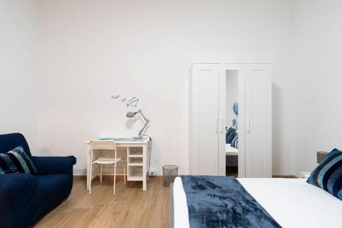 a bedroom with a bed and a chair and a desk at The Flower House by Wonderful Italy in Bitritto