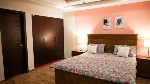 a bedroom with a large bed and two lamps at Fully furnished 1BHK, Bahria heights 1 in Rawalpindi