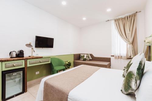 a hotel room with a bed and a couch at Boutique Suites 186 in Sorrento