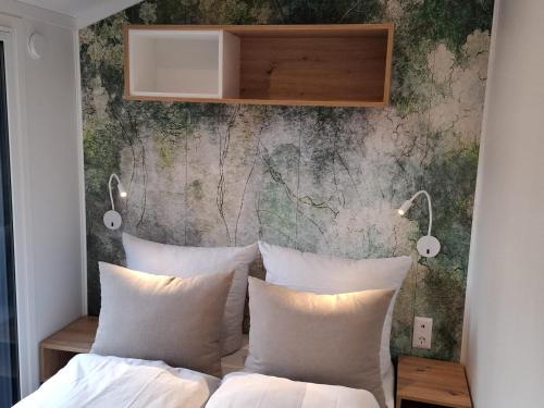 a bedroom with two beds and a wall at LandZeit - get your tiny moments in Sohren