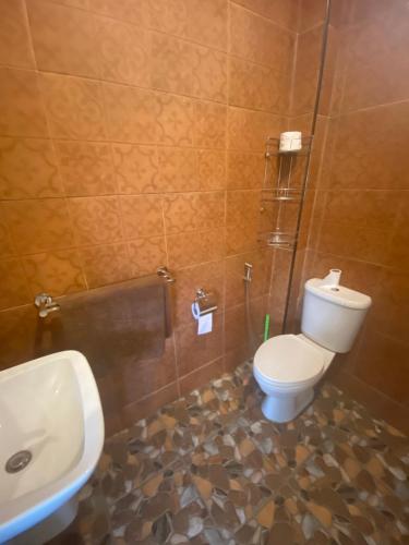 a bathroom with a toilet and a sink at Thai style 3 bedroom pool house. in Khao Lak
