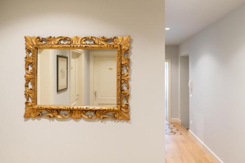 a mirror on a wall in a room at Palazzo Biasini by Postcardsfrom in Verona