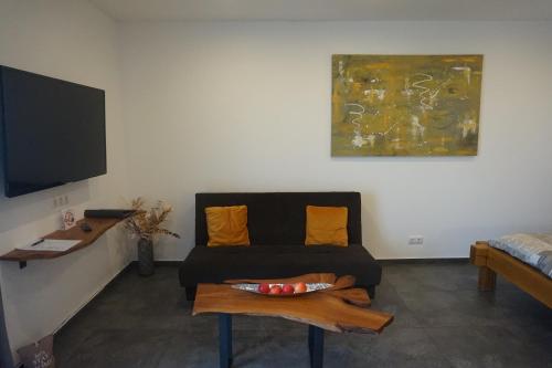a living room with a couch and a table at Wohnung 1 im Kirschblütenhof in Ingelheim am Rhein