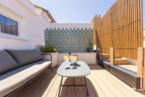 a patio with a couch and a table on a balcony at Boutique Suites 186 in Sorrento
