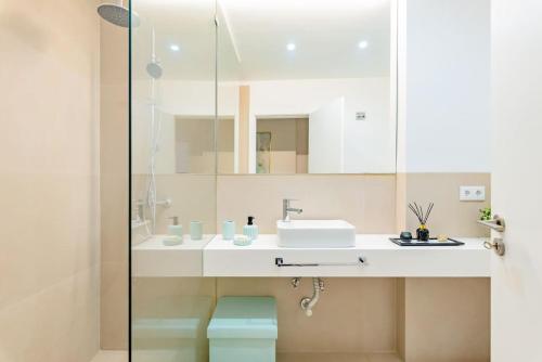 a bathroom with a sink and a mirror at A Coastal Retreat in Oeiras in Paço de Arcos