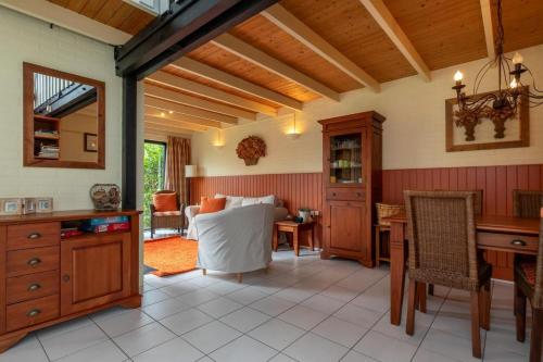 a kitchen with a table and a dining room at Welcome in - Vakantiehuisje Nr 86, Op een vakantiepark met zwembad, ruime en zonnige tuin in Burgh Haamstede