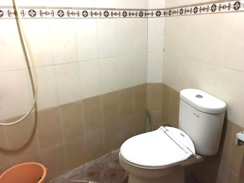 a bathroom with a toilet and a shower at Hotel Alami near Alun-Alun Klaten in Klaten