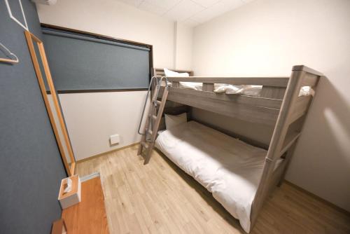 a room with a bunk bed in a room at 4S STAY Awaikeda ikedaonsenyoko in Miyoshi