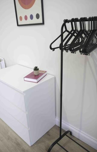 a black iron rack next to a white table at Dalviat Getaway in Balloch