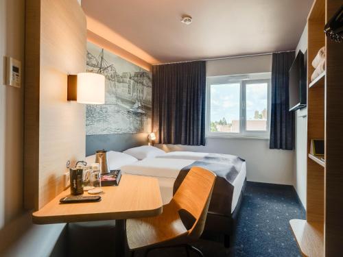 Postel nebo postele na pokoji v ubytování B&B Hotel Oldenburg