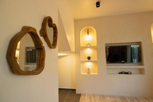 a room with a mirror and a tv on a wall at Nafsi Nomad in Paje