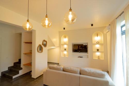 a living room with a couch and some lights at Nafsi Nomad in Paje