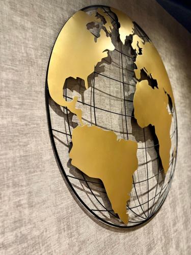 a metal globe with a gold dollar sign on it at Kyriad Paris 18 - Porte de Clignancourt - Montmartre in Paris
