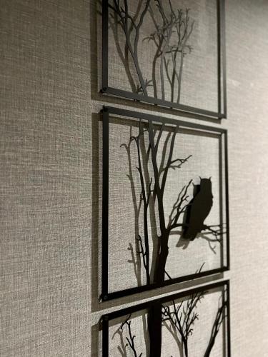 a window with a bird sitting in a tree at Kyriad Paris 18 - Porte de Clignancourt - Montmartre in Paris