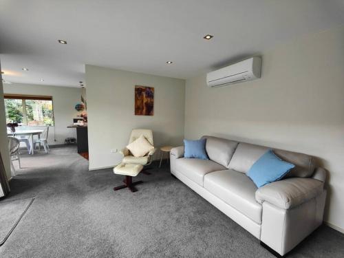 a living room with a couch and a chair at Quiet in the Court in Lorneville