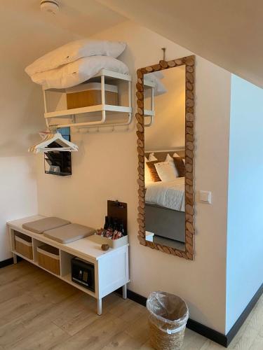 a bedroom with a bed and a mirror at Vida Verde in Valkenburg