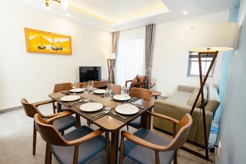 a dining room with a table and chairs at Full Moon Apartments & Villa - Hoi An in Hoi An