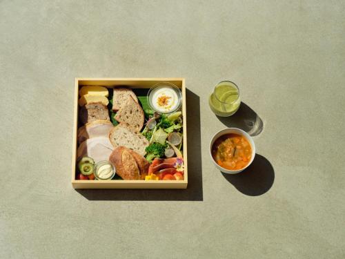 a bento box with food and a bowl of soup at YAWN YARD Kouri Island in Kouri