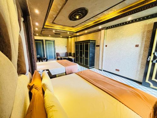 a hotel room with two beds and a window at Yuki Grand Hotel in Athurugiriya