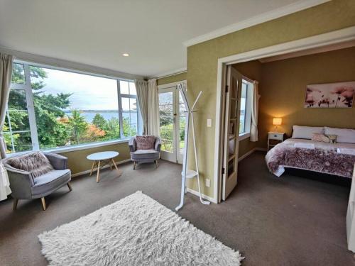 a bedroom with a bed and a large window at Villa Vista in Riverton
