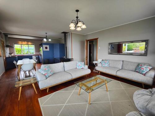 a living room with two couches and a table at Villa Vista in Riverton