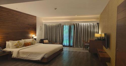 a bedroom with a large bed and a window at The Golkonda Resort and Spa in Hyderabad