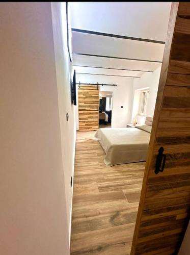 a hallway leading to a bedroom with a bed at Sofia's House Lago di Bolsena in Marta