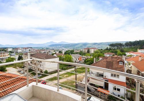 a view of a city from the balcony of a building at The High View Ioannina in Ioannina
