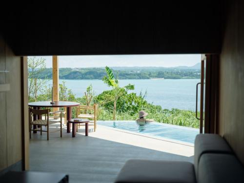 a view from the living room of a house with a pool at YAWN YARD Kouri Island in Kouri