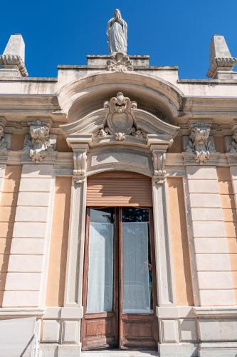 a building with a statue on top of it at Villa San Giuseppe in Brescia