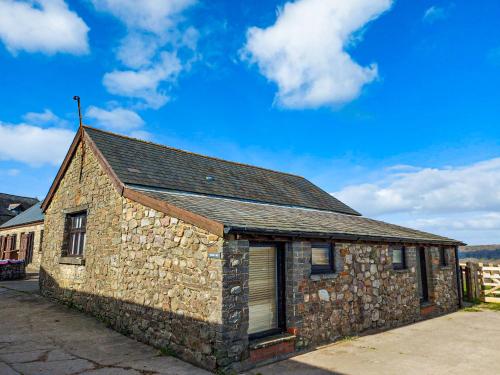 a stone building with a window and a roof at Clyne Farm Centre in The Mumbles