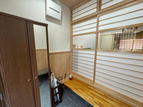 a room with wooden floors and a large window at 木香の家-天下茶屋 in Osaka
