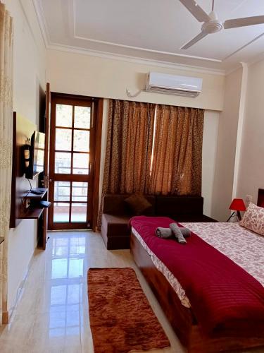 a bedroom with a bed and a couch in it at Yogvan Luxury 1BHK Apartments Tapovan Rishikesh in Rishīkesh